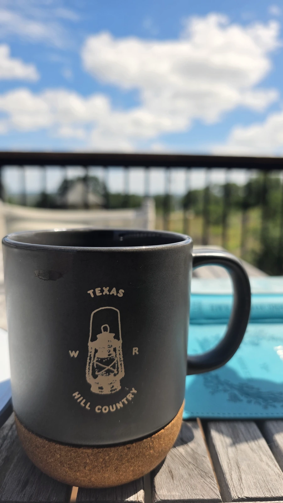A warm mug of coffee with a Texas Hill Country design